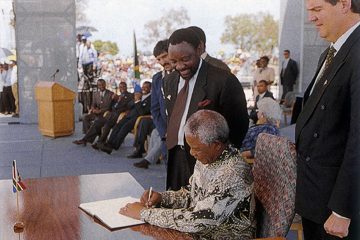 Nelson Mandela signing the new South African Constitution 