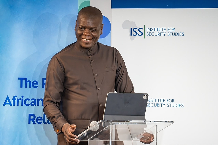 Man speaking: Ronald Lamola. Minister of International Relations and Cooperation, South Africa, giving the Keynote Address