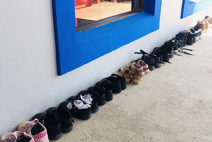 A line of shoes: The children's shoes outside their new classroom at Little Flower ECD centre, Nkantolo Village